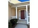 Beige house with a red brick garage and a covered front porch at 4628 Rolling Brook Ct, Union City, GA 30291