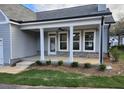 Covered porch with white columns and brick flooring at 241 Saratoga Dr, Acworth, GA 30102