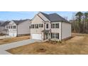 Two-story home with a front yard and driveway at 988 Blue Juniper Cir, Loganville, GA 30052