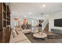 Open-concept living area with a sectional sofa, dining table, and view of the kitchen at 1363 Midnight Ride Ct, Hampton, GA 30228