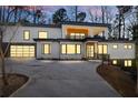 Modern home exterior illuminated at dusk, showcasing architectural details at 4366 Skyland Ne Dr, Atlanta, GA 30342