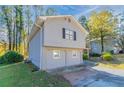 Gray house showcasing the side view with a two-car garage at 5382 Kemper Pl, Stone Mountain, GA 30088