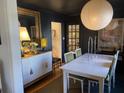 Elegant dining room with a white table and dark walls at 496 Overbrook Nw Dr, Atlanta, GA 30318