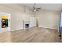 Spacious living room featuring hardwood floors, a fireplace, and built-in shelving at 2627 Elsinore St, East Point, GA 30344