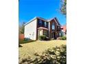 Two story house with brick and vinyl siding, showcasing a side view at 408 Othello Dr, Hampton, GA 30228