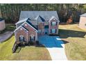 Two-story home, large backyard, and a long driveway at 168 Waypoint Dr, Stockbridge, GA 30281