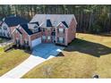 Brick house with a three-car garage and large yard at 168 Waypoint Dr, Stockbridge, GA 30281