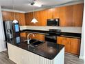 Spacious kitchen with island, stainless steel appliances, and wood cabinets at 711 Cosmopolitan Ne Dr # 426, Atlanta, GA 30324