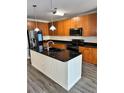 Spacious kitchen with island, stainless steel appliances, and wood cabinets at 711 Cosmopolitan Ne Dr # 426, Atlanta, GA 30324