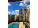 Community swimming pool with surrounding patio furniture and views of building at 711 Cosmopolitan Ne Dr # 426, Atlanta, GA 30324