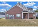Rear view of brick townhouse, showing a patio and yard at 2555 Flat Shoals Rd # 1801, Atlanta, GA 30349