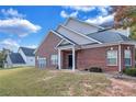 Brick townhouse exterior showcasing a side view and landscaping at 2555 Flat Shoals Rd # 1801, Atlanta, GA 30349