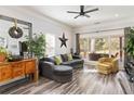 Spacious living room featuring a comfortable sectional sofa and large windows at 4900 Lilburn Stone Mountain Sw Rd, Lilburn, GA 30047