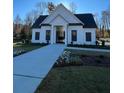 White community clubhouse with a covered entrance and landscaping at 4830 Briscoe Dr, Cumming, GA 30028