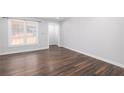 Living room with dark hardwood floors and neutral walls at 4054 Coopers Hill Se Dr, Smyrna, GA 30080