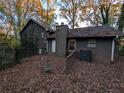 Home's backyard with deck and a wooded area at 4922 Rock Springs Rd, Lithonia, GA 30038