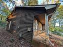House exterior showcasing wooden siding and a side porch at 4922 Rock Springs Rd, Lithonia, GA 30038