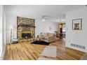 Living room with stone fireplace and hardwood floors at 3798 Valley Brook Rd, Snellville, GA 30039