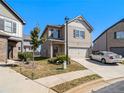 Two-story house with beige siding, attached garage, and a front yard at 2291 Elise Way, Hampton, GA 30228