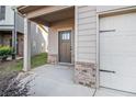 Modern dark brown front door with sidelights, and a brick walkway at 2291 Elise Way, Hampton, GA 30228