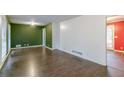 Spacious living room with dark wood-look floors and green accent wall at 4796 Fairforest Dr, Stone Mountain, GA 30088