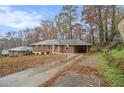 Ranch house with a driveway and mature trees at 2052 Brannen Se Rd, Atlanta, GA 30316