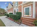 Inviting front entrance with a brick staircase and green door at 1130 Whitehawk Trl, Lawrenceville, GA 30043