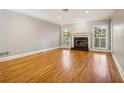 Spacious living room featuring hardwood floors, fireplace, and large windows at 230 Wessex Ct, Atlanta, GA 30328