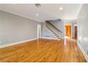 Hardwood floors, staircase, and neutral walls grace this open living room at 230 Wessex Ct, Atlanta, GA 30328