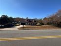 House with a large yard and driveway, seen from across the street at 1350 Cedars Rd, Lawrenceville, GA 30045