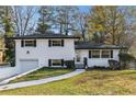 Newly renovated ranch home with white brick exterior, and a grassy yard at 2178 Shamrock Dr, Decatur, GA 30032