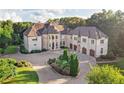 Grand estate with a long driveway and manicured lawns at 1513 Jones Rd, Roswell, GA 30075