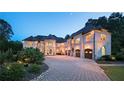 Elegant brick home with extensive landscaping and a large driveway at 1513 Jones Rd, Roswell, GA 30075