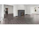 Open living room with hardwood floors, fireplace, and views to kitchen at 2044 Fairhaven Cir, Atlanta, GA 30305