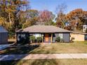 Newly renovated ranch home with dark exterior and orange door at 921 Byron Sw Dr, Atlanta, GA 30310