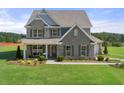 Two-story house with gray brick exterior and a landscaped yard at 4055 Newburn Ct, Cumming, GA 30028