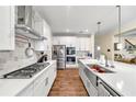 Modern kitchen featuring white cabinets, quartz countertops, and a farmhouse sink at 1927 Streamlet Xing, Kennesaw, GA 30152