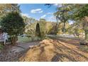 Spacious backyard with mature trees and a large grassy area at 2081 Dodson Sw Dr, Atlanta, GA 30311