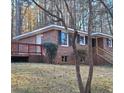 Brick ranch house with a wooden deck and surrounding trees at 2289 Addison Rd, Marietta, GA 30066