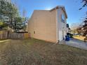 Rear view of house showcasing a side yard and garage at 2754 Topaz Rd, Riverdale, GA 30296