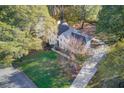 An aerial view showcasing a house nestled amongst lush green trees at 3782 Brookside Pkwy, Decatur, GA 30034