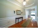 Elegant entryway with hardwood floors and decorative mirror at 6135 Mapperley Ln, Cumming, GA 30041