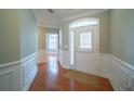 Bright entryway with hardwood floors and white wainscoting at 6135 Mapperley Ln, Cumming, GA 30041