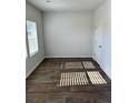 Bright bedroom with neutral walls, wood-look flooring, and window with blinds at 504 Overlook Rd, Covington, GA 30052