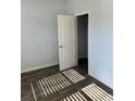 Spacious bedroom with neutral walls, wood-look flooring, and a large closet at 504 Overlook Rd, Covington, GA 30052