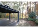 Covered patio gazebo with a view of a wooded backyard at 1873 Jameson Cir, Lawrenceville, GA 30043