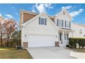 Two-story house with white siding, a two-car garage, and manicured lawn at 7370 Gossamer St, Union City, GA 30291