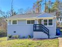 Newly renovated light gray brick home with modern black railings at 2211 Macon Sw Dr, Atlanta, GA 30315