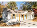 Newly built home with white siding, light gray roof, and a light blue front door at 413 Cranfill Se Rd, Marietta, GA 30060