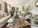 Spacious living room with fireplace, zebra rug, and piano at 20 Pointe Se Ter, Atlanta, GA 30339